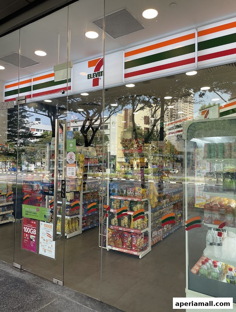 The entrance of a 7-Eleven convenience store, showcasing shelves stocked with snacks and drinks.