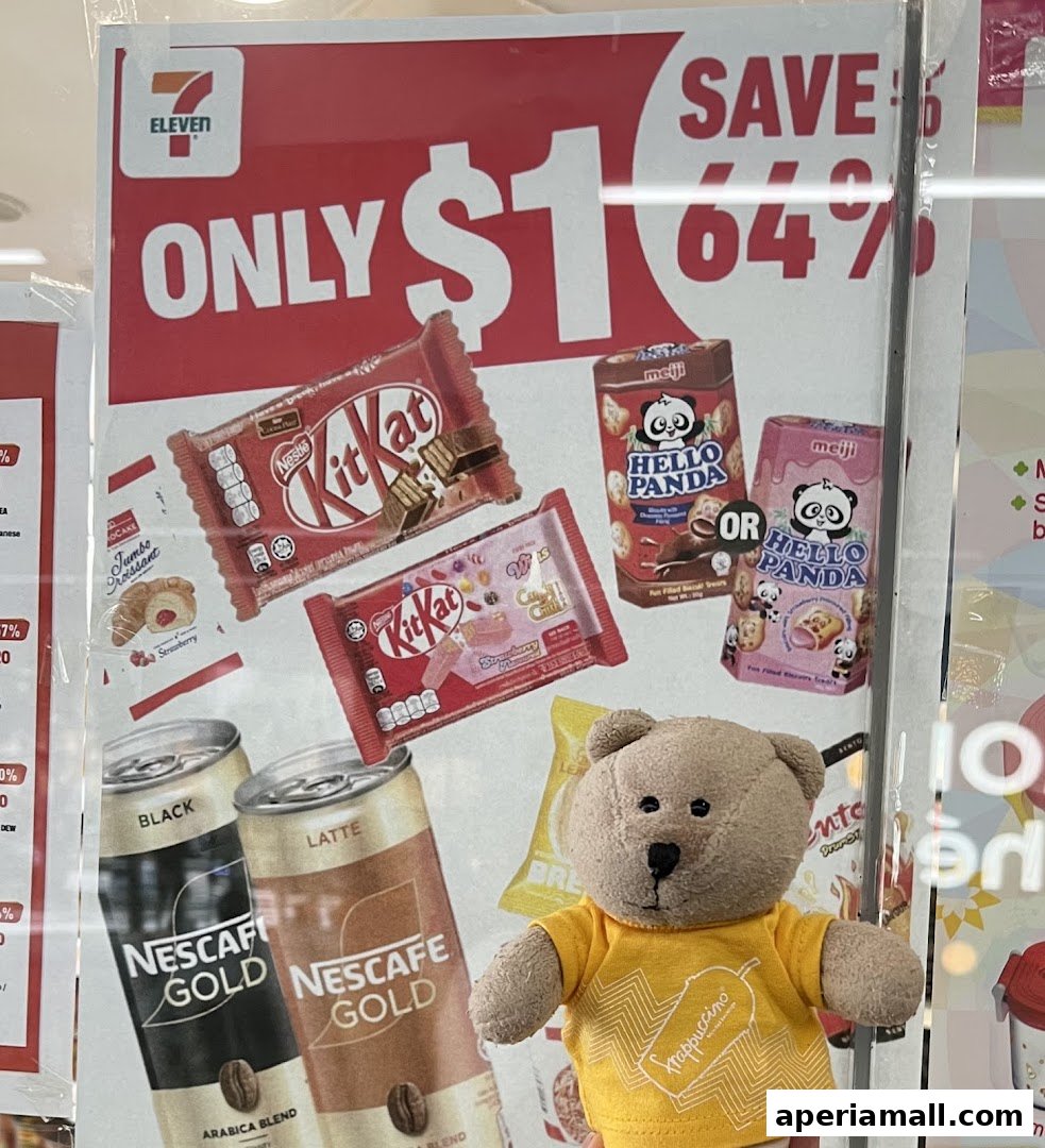 A 7-Eleven advertisement featuring Kit Kat, Hello Panda, and Nescafé Gold with a teddy bear.