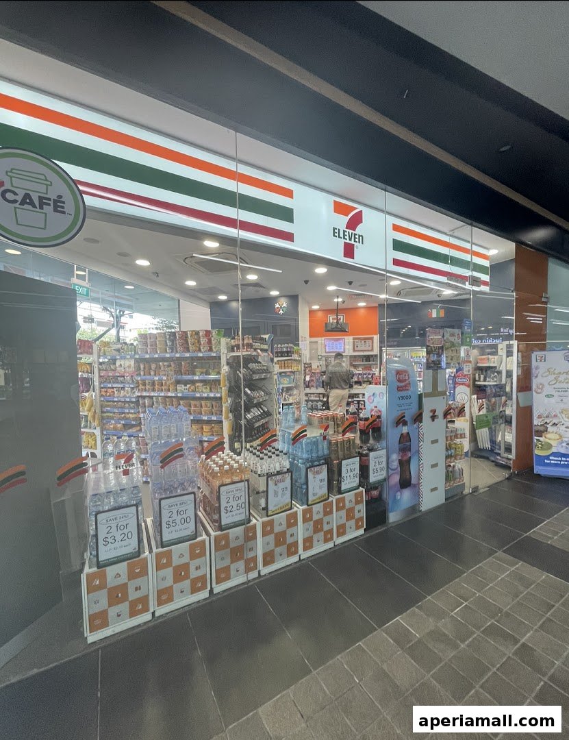 The exterior of a 7-Eleven convenience store with drinks and snacks displayed.