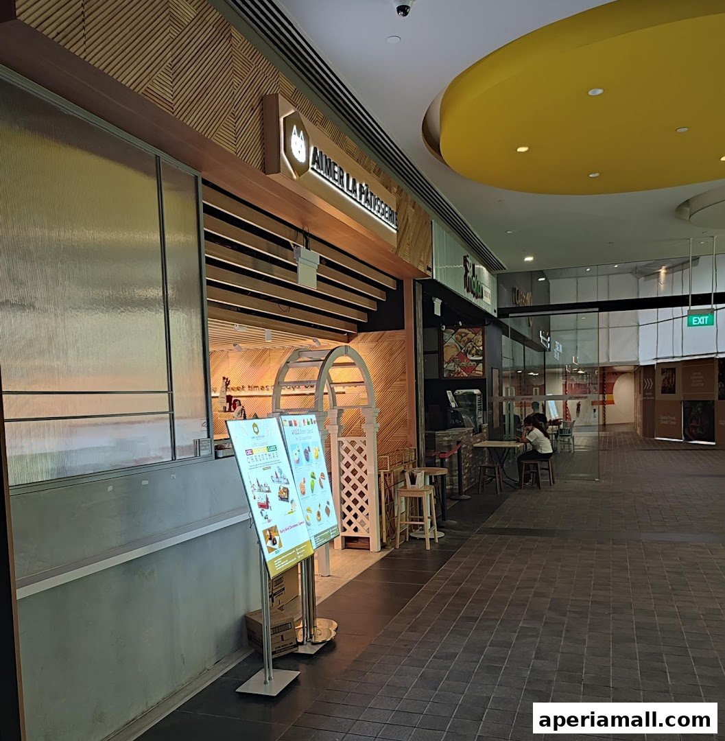 The exterior of Aimer La Patisserie, a charming French pastry shop with an inviting entrance.