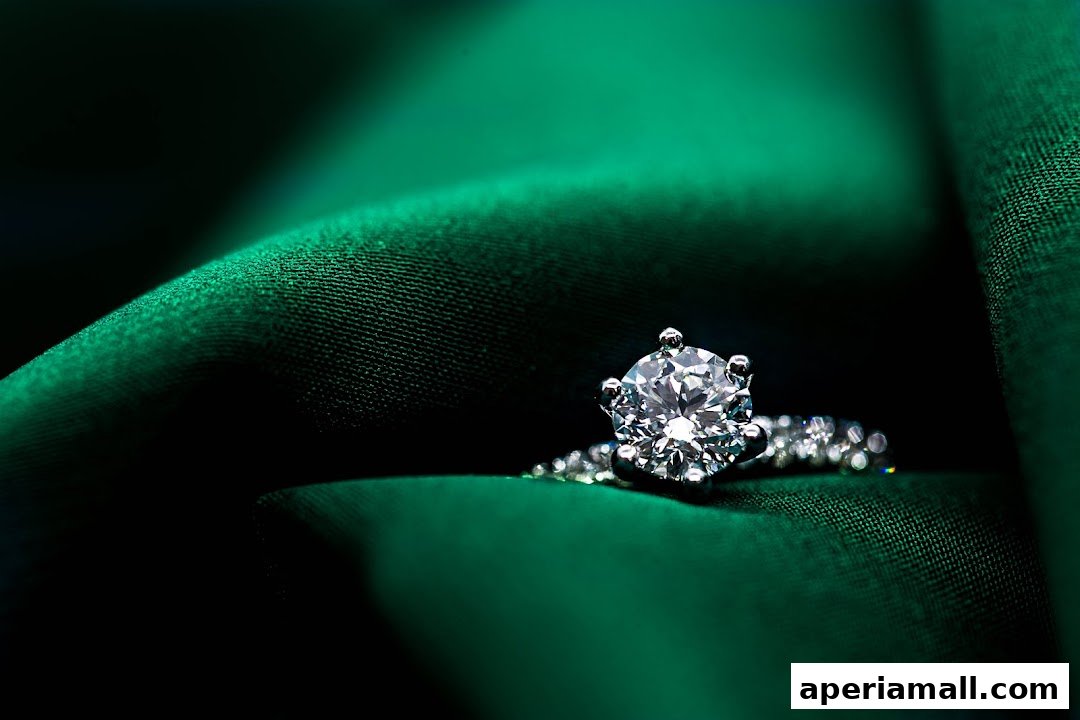A sparkling diamond ring rests on luxurious green fabric.