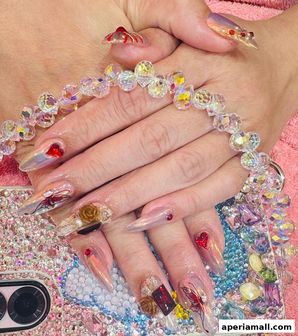 Elaborately decorated nails with rhinestones, butterflies, and hearts, held together by a crystal chain.