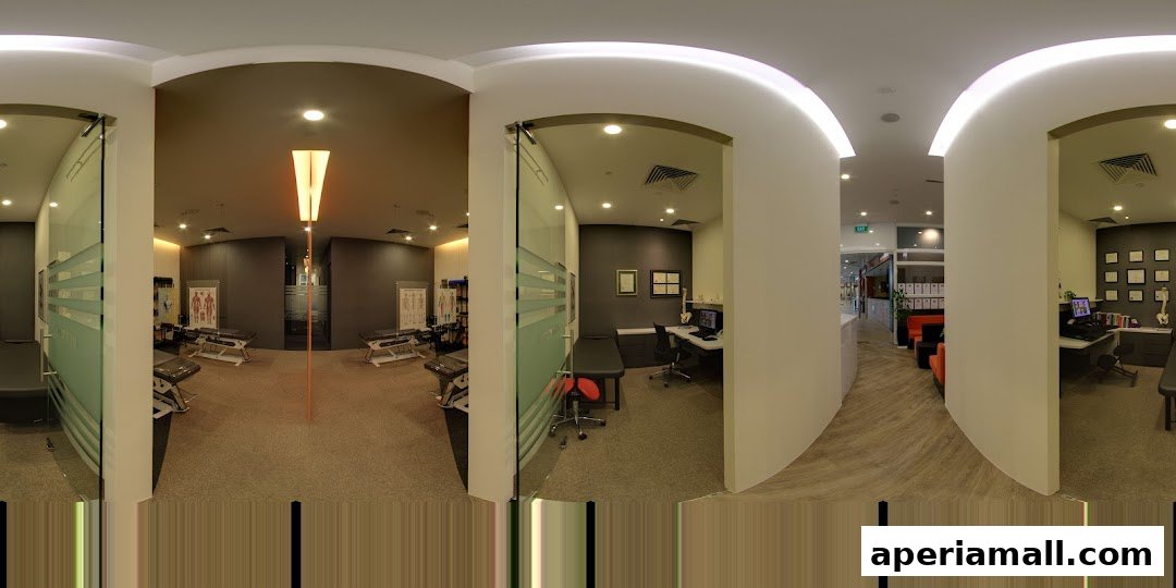 Interior view of a modern chiropractic clinic with treatment tables and consultation areas.