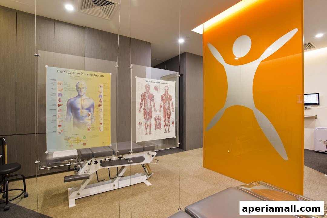 Interior of a chiropractic clinic with examination tables and anatomical charts.