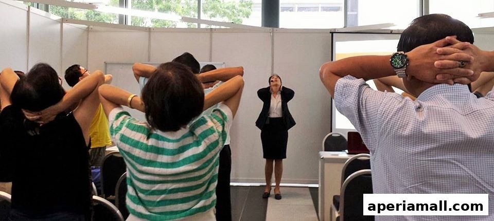 A group of people are participating in a posture correction class led by an instructor.