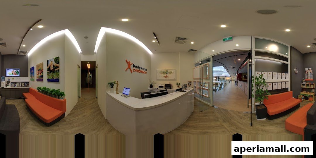 The reception area of Bodyworks Chiropractic Singapore, featuring a modern reception desk and waiting area.
