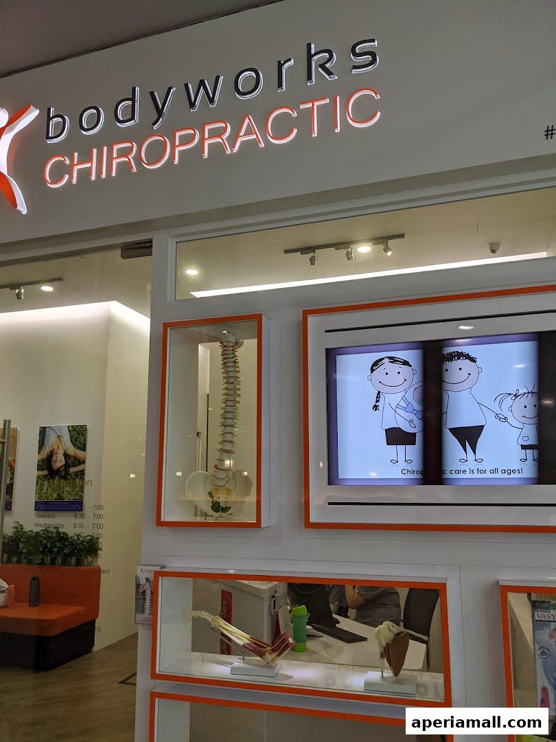 The exterior of Bodyworks Chiropractic Singapore, featuring its illuminated sign and display windows.