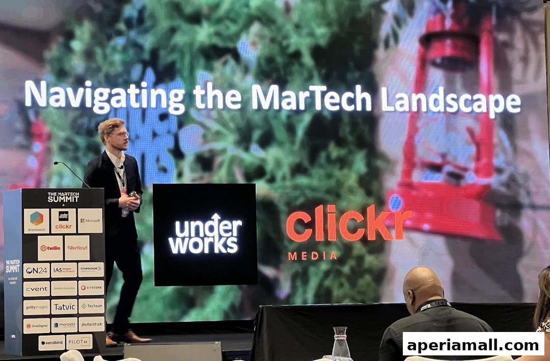 A speaker presents at The MarTech Summit with Clickr Media logo displayed.