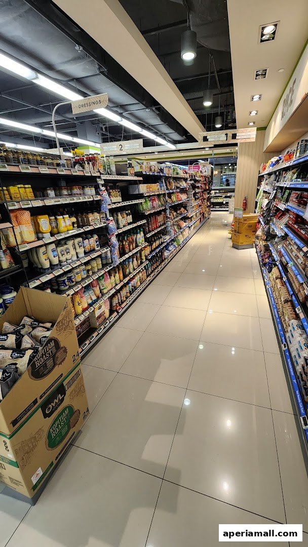 Aisle view of a well-stocked supermarket with shelves full of various food products.