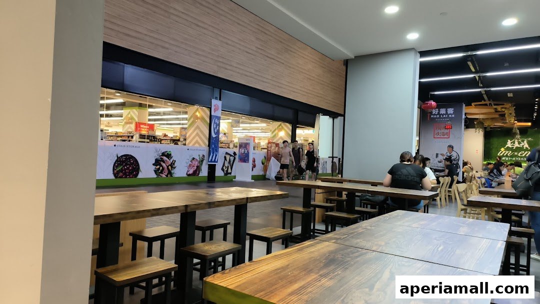 Interior view of a Cold Storage supermarket with seating areas and other shops visible.