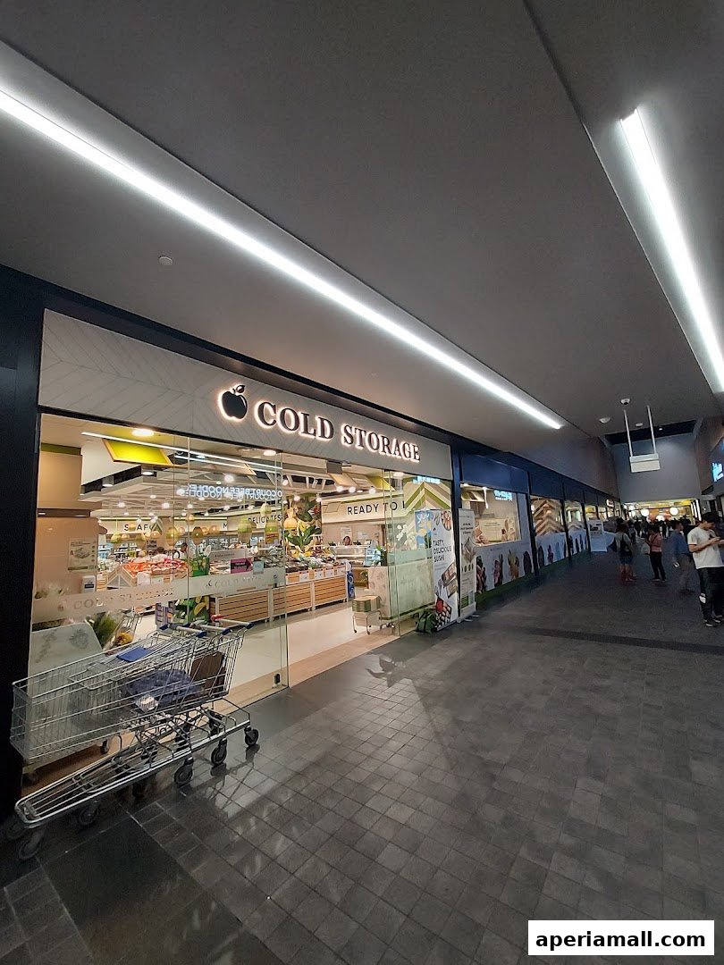 The exterior of a Cold Storage supermarket with shopping carts outside.