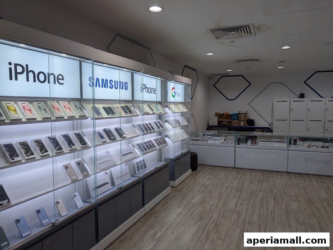 A well-lit electronics store showcasing rows of iPhones, Samsung, and Google Pixel phones on display.