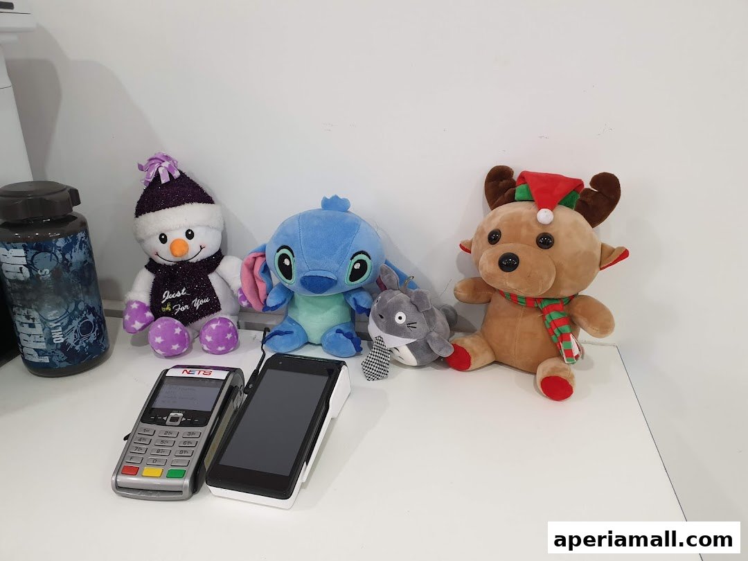 Plush toys including a snowman, Stitch, Totoro, and a reindeer with payment terminals.