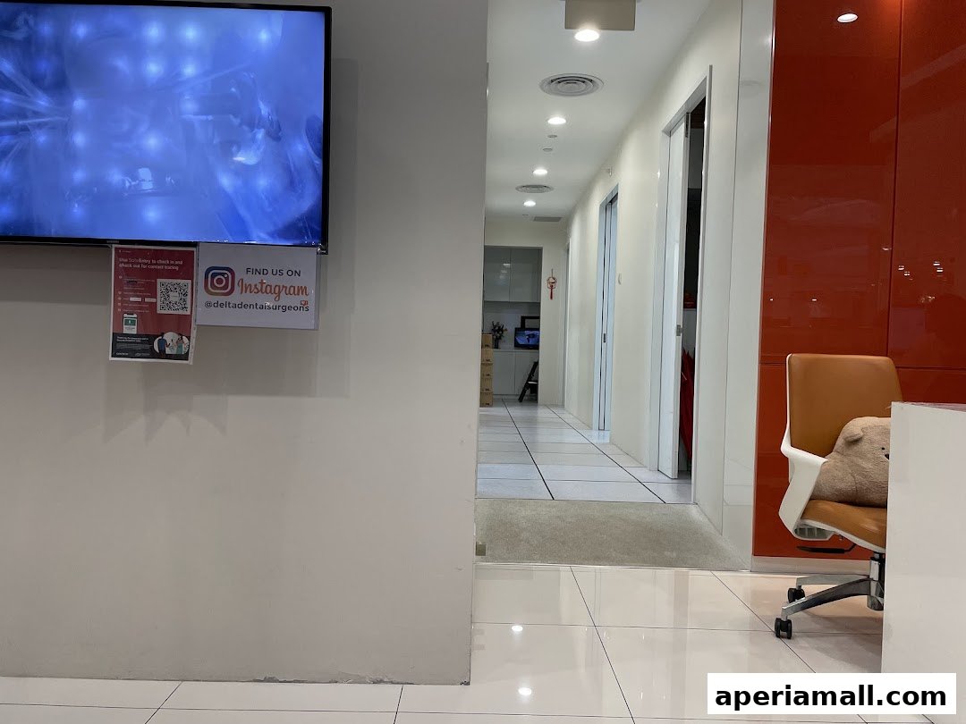 Interior view of a dental clinic hallway with a TV screen and Instagram promotion.