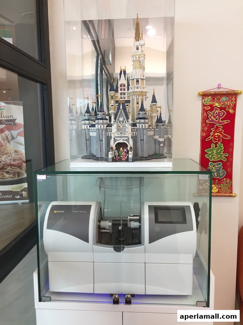 A display case with a Lego castle and dental equipment, next to a Chinese New Year banner.