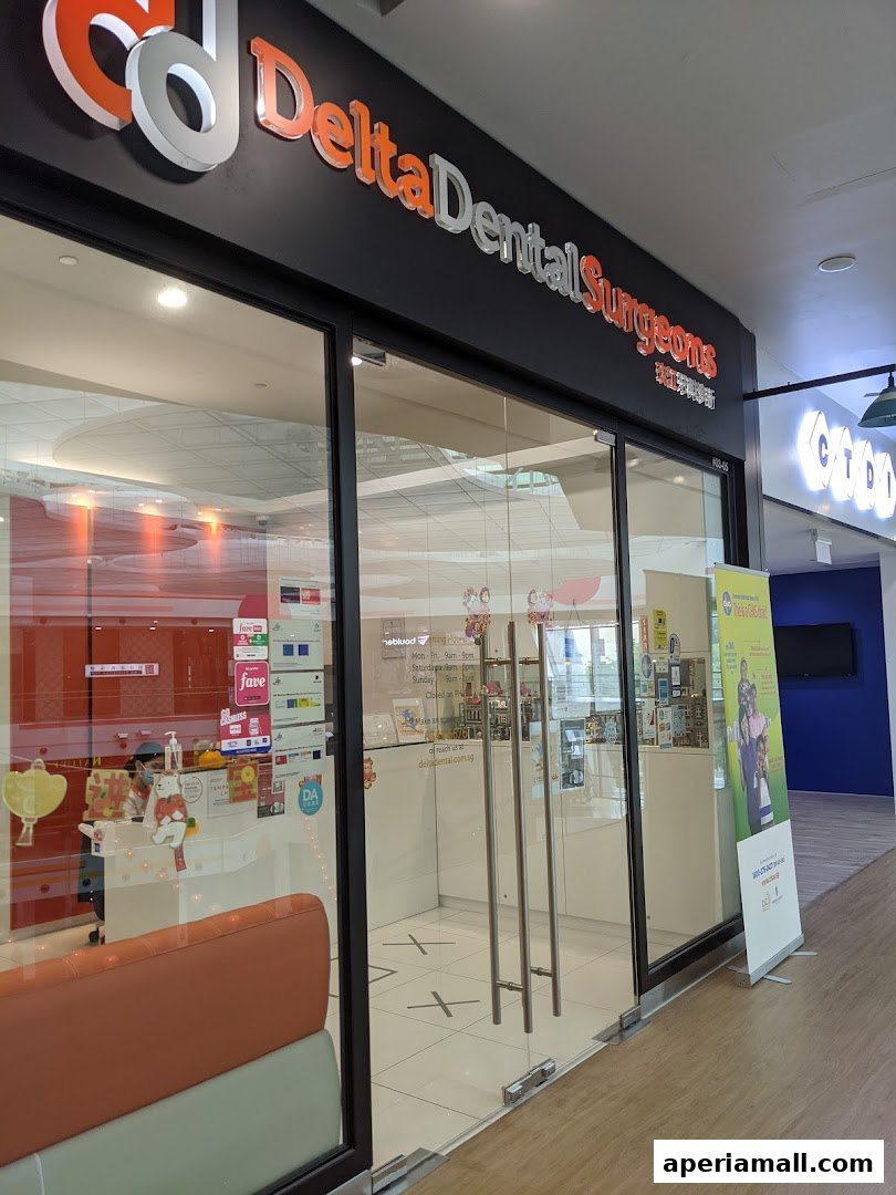 The entrance to Delta Dental Surgeons, a modern dental clinic with glass doors and signage.