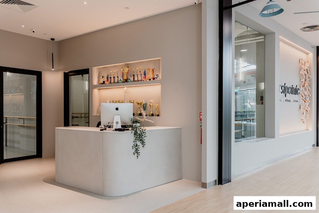The reception area of a dance school with trophies displayed on shelves.