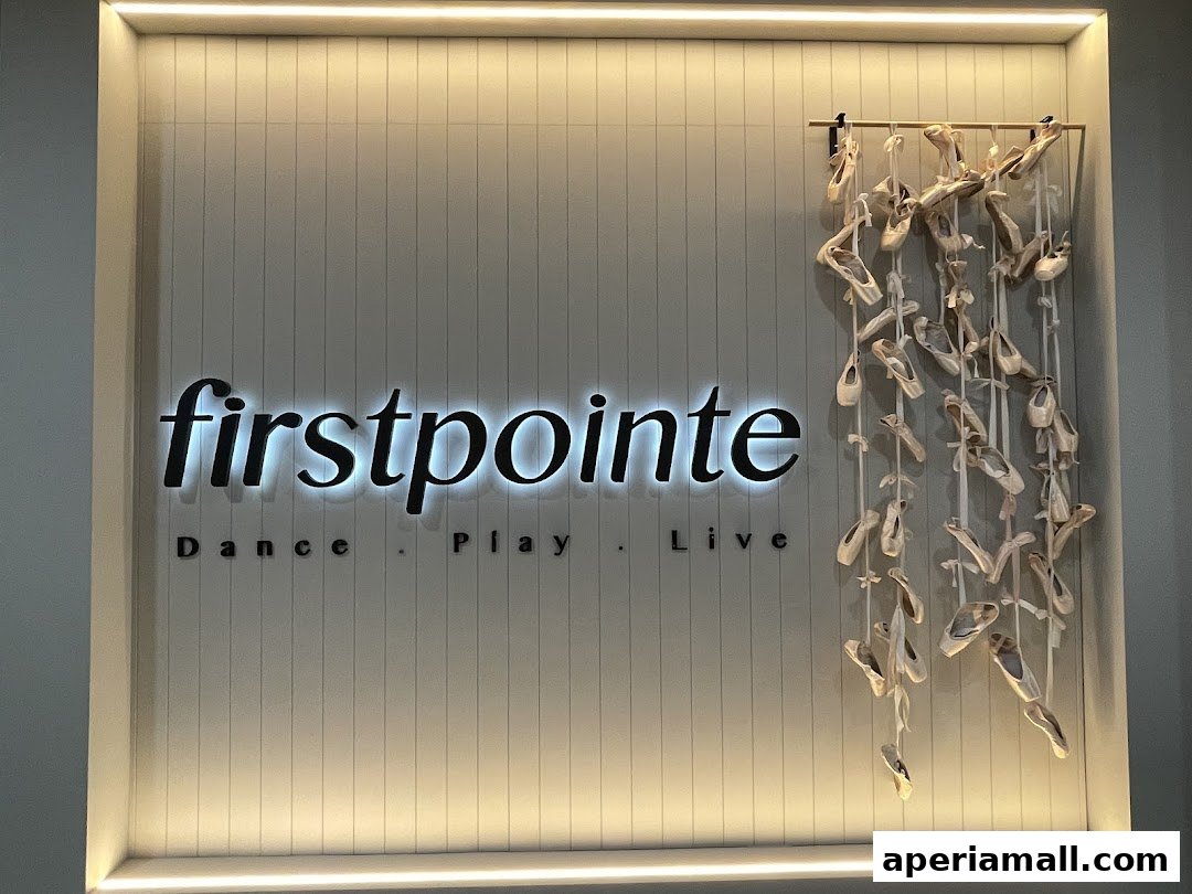 Firstpointe School of Dance logo with ballet shoes hanging decoratively.