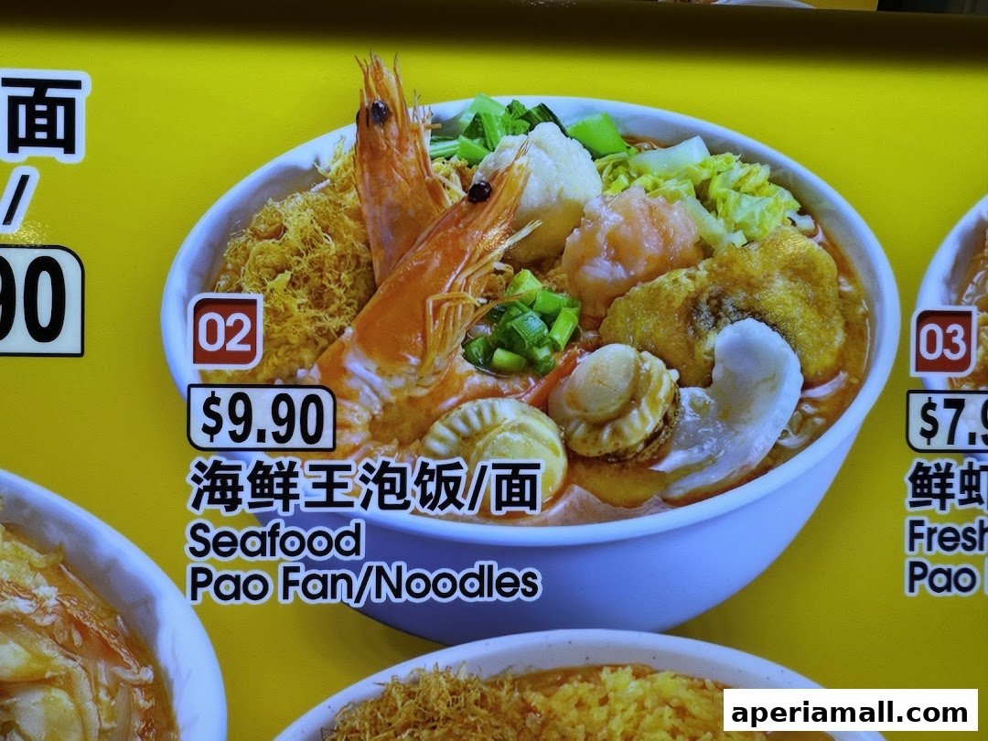 A close-up of a delicious seafood noodle dish with large shrimp and scallops.