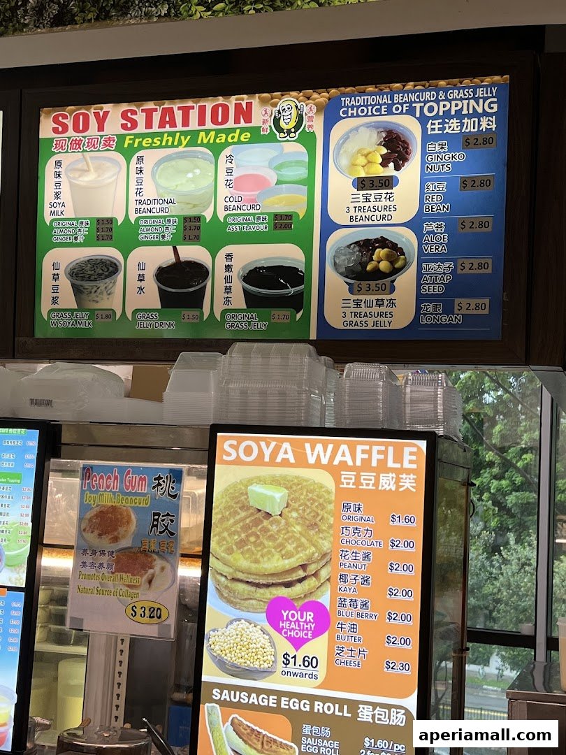 A menu board displaying various soy-based drinks, desserts, waffles, and sausage egg rolls.