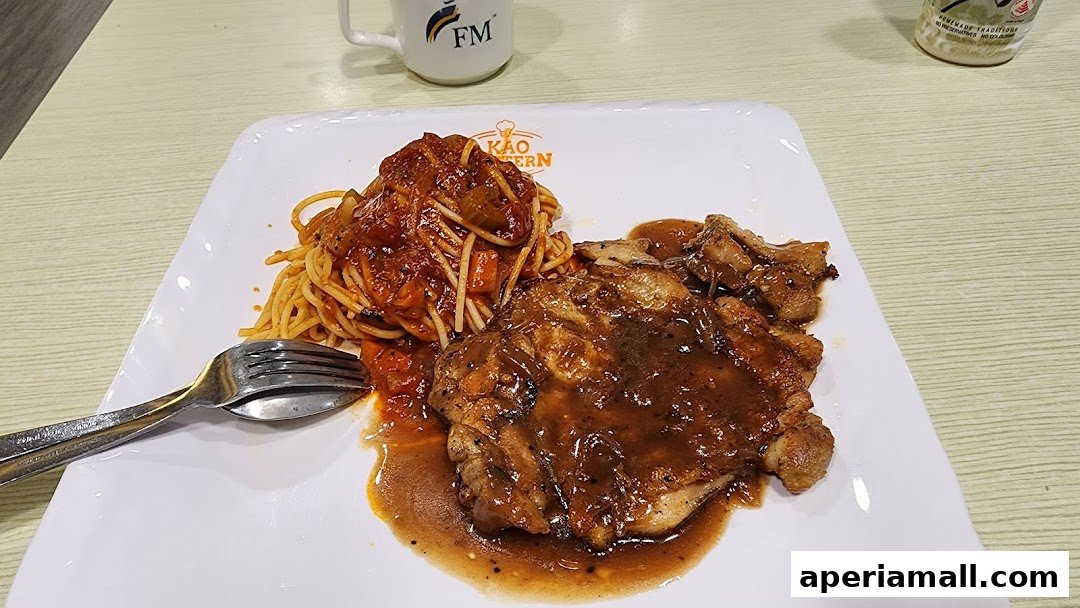 A plate of chicken chop with spaghetti and a mug with FM logo.