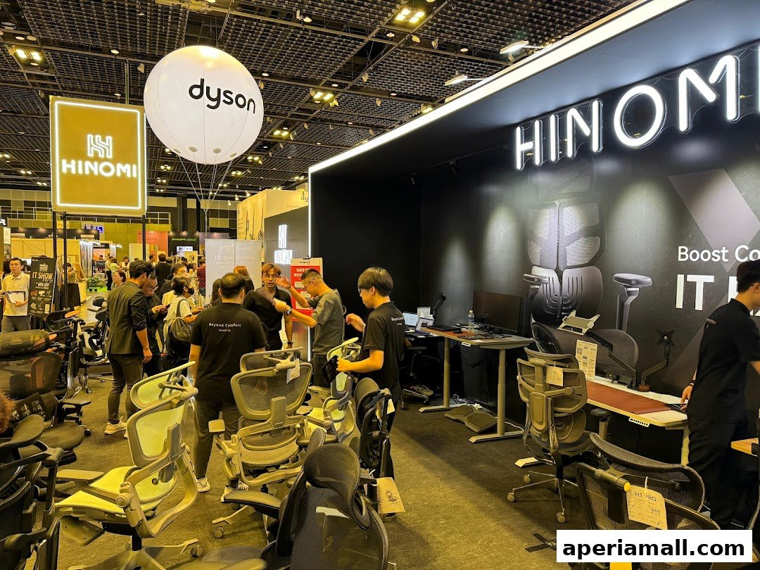 A busy showroom with many ergonomic chairs and people browsing.