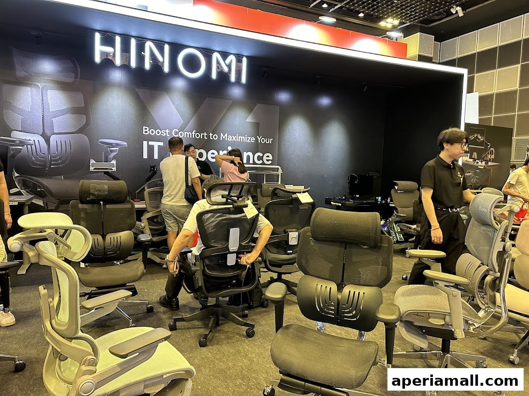 People are trying out ergonomic chairs at the Hinomi Singapore Showroom.