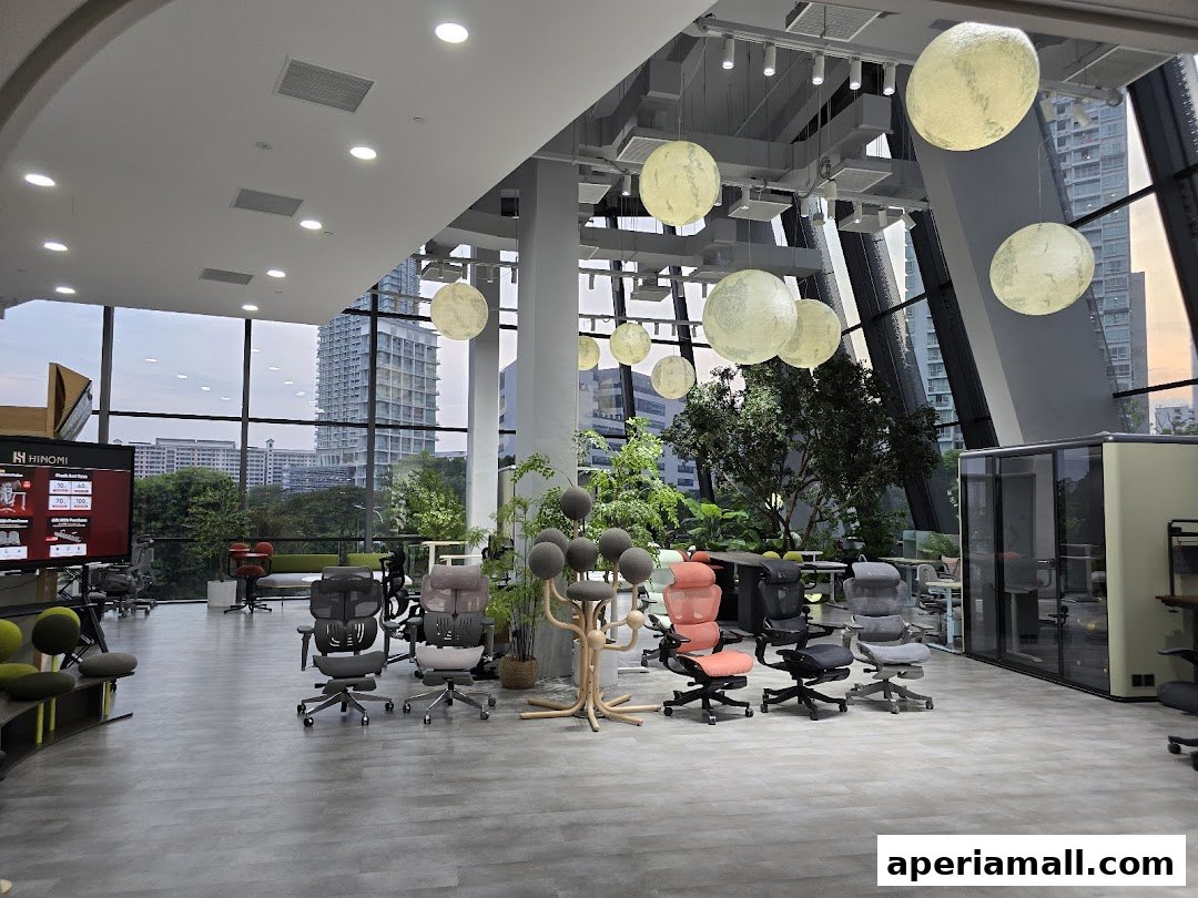 Interior of a modern showroom displaying ergonomic chairs and office furniture with large windows.