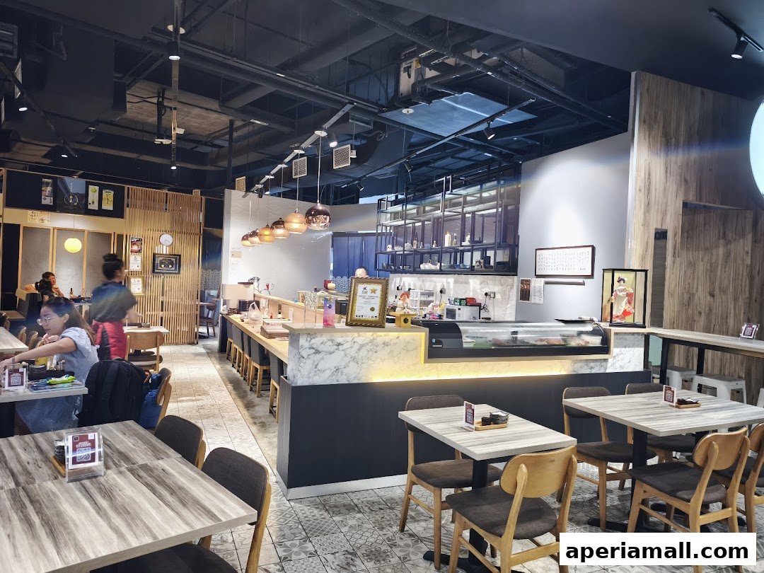 Interior view of a modern Japanese restaurant with sushi bar and dining tables.