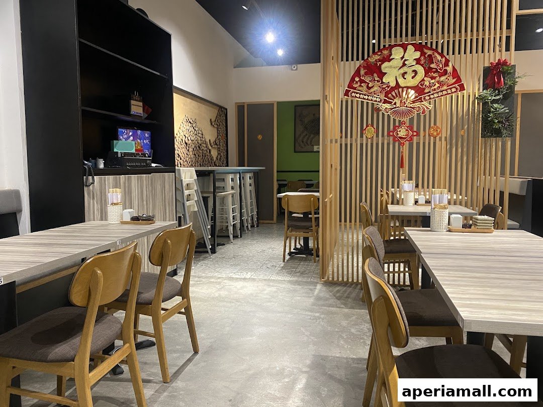 Interior view of a Japanese restaurant with tables, chairs, and decorative elements.
