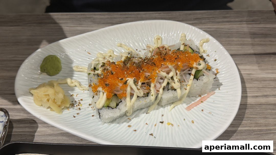 A plate of sushi rolls with toppings, wasabi, and pickled ginger.