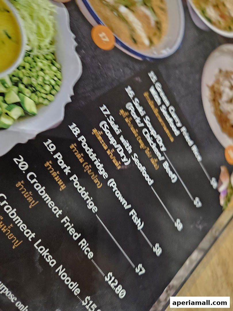 A close-up of a Thai food menu featuring various dishes with prices.