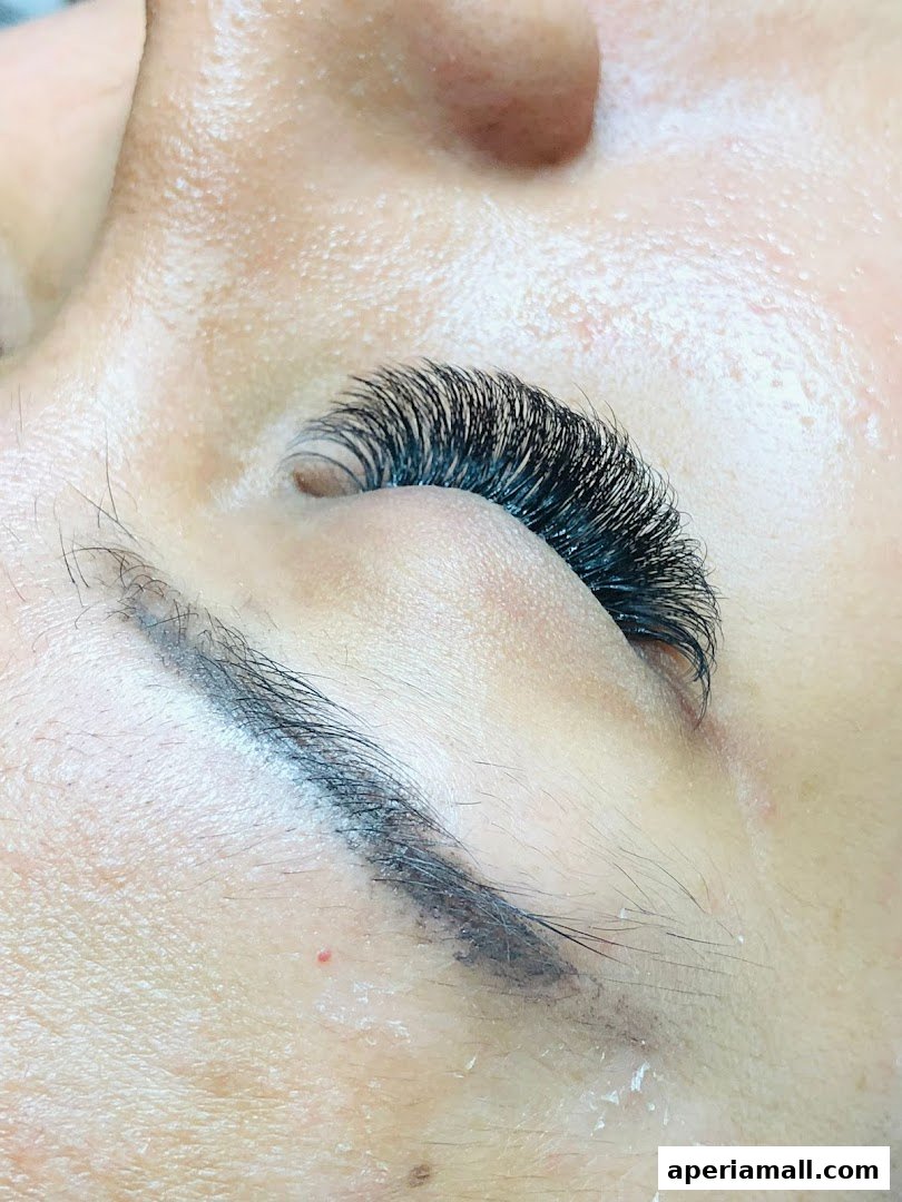 Close-up of a person's eye with dramatic, voluminous eyelash extensions applied.