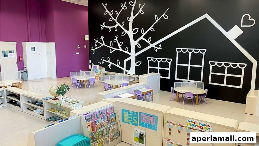 A bright and colorful classroom interior with child-sized tables, chairs, and educational displays.
