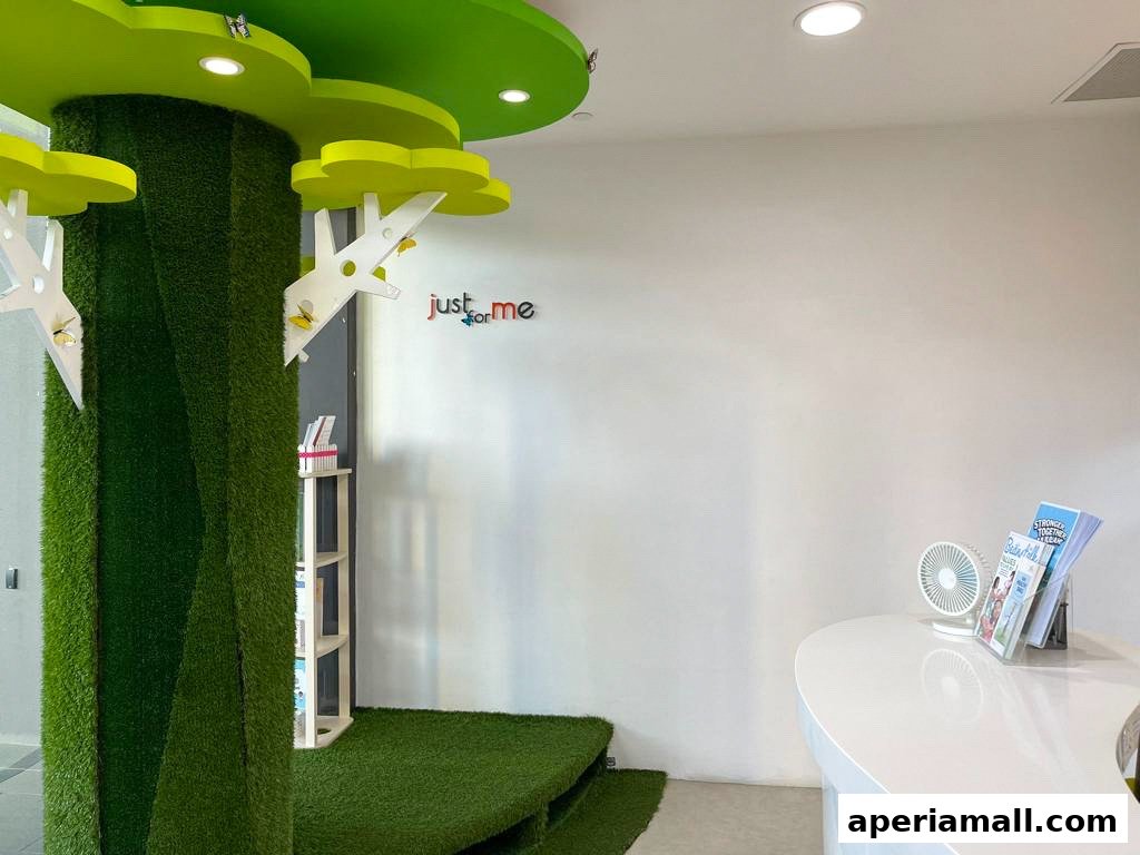 Interior of a children's learning center with a tree-themed pillar and a reception desk.