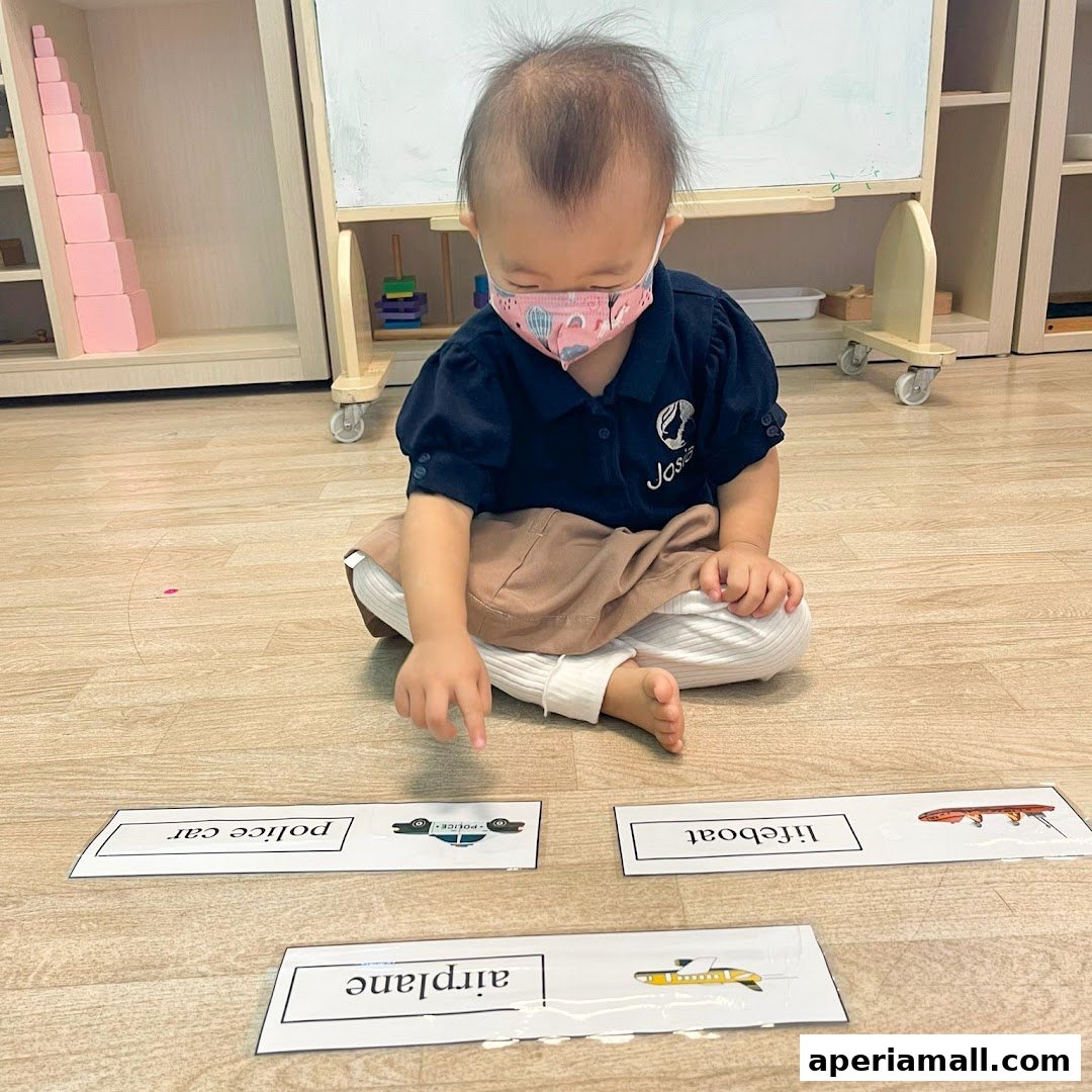 A child wearing a mask learns with flashcards of vehicles at Josiah Montessori Aperia.