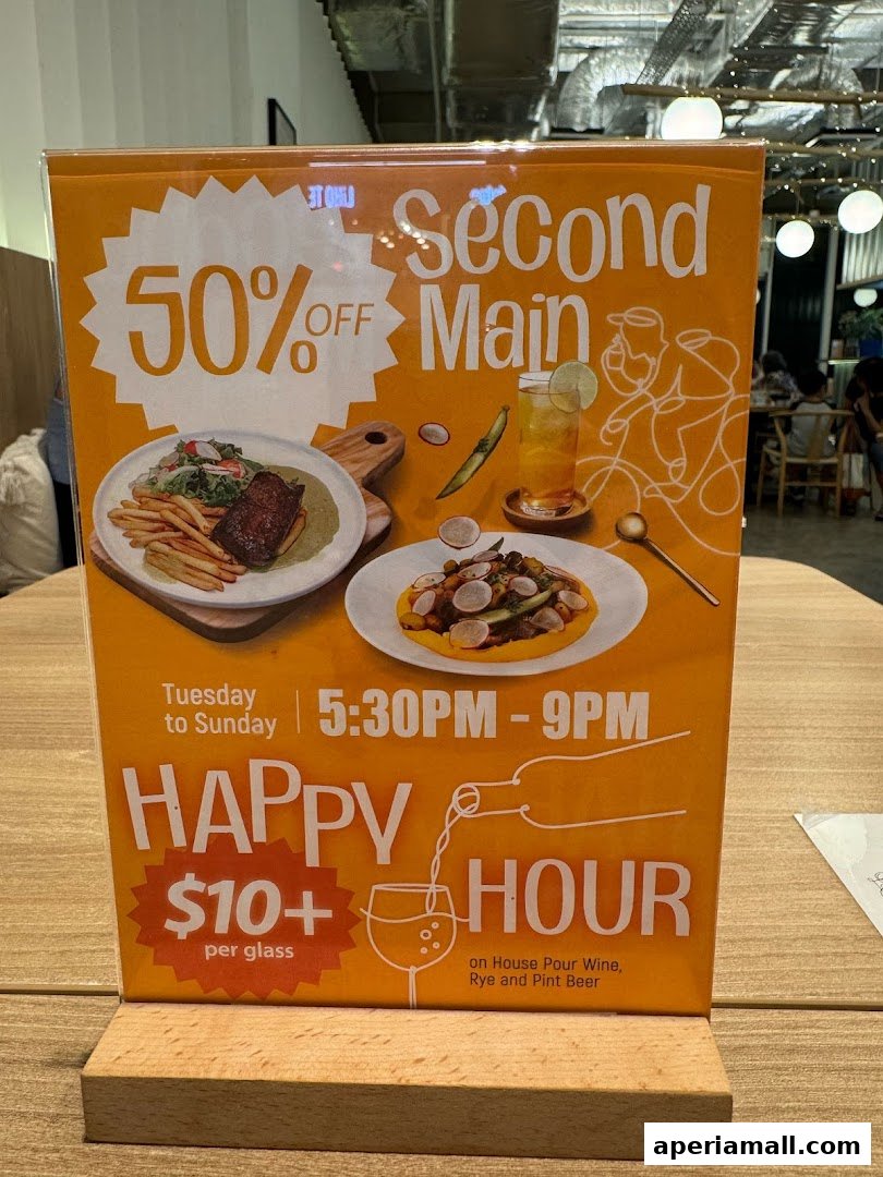 A sign advertising 50% off second mains and happy hour deals at Kaeden.
