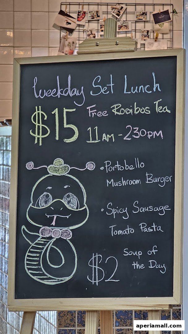 A chalkboard menu advertising a weekday set lunch with a cartoon snake illustration.
