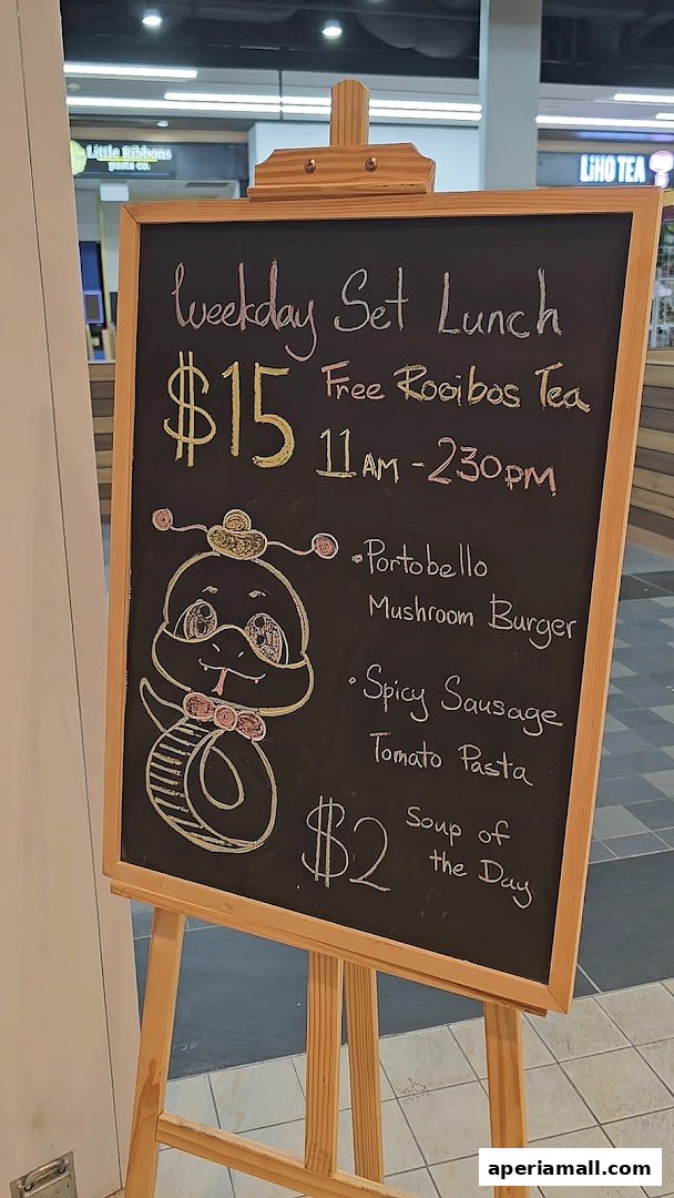 A chalkboard menu advertising a weekday set lunch with meal options and soup of the day.