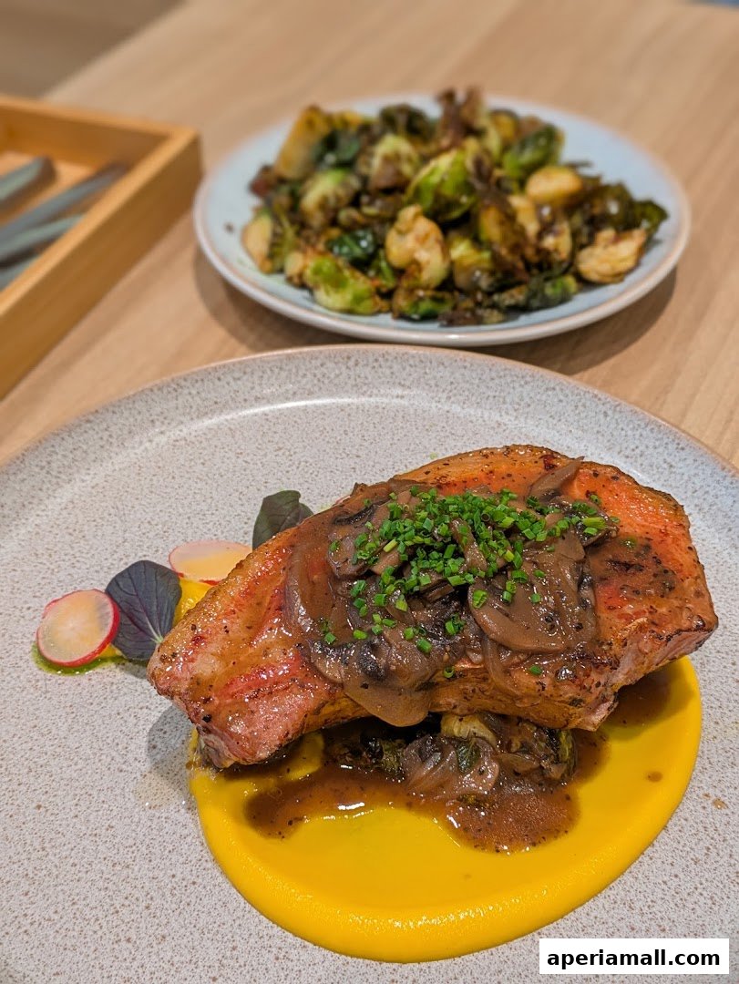 A beautifully plated dish featuring a piece of salmon topped with mushrooms and chives, served with Brussels sprouts.
