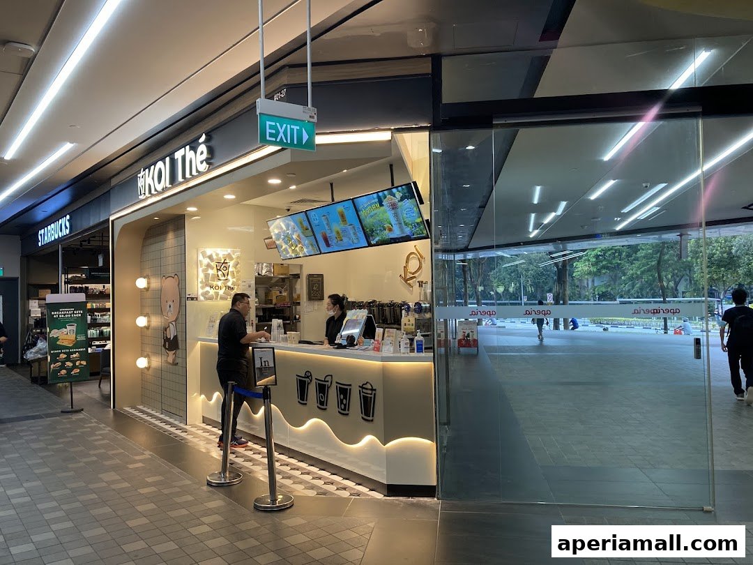 The KOI Thé shop front with staff serving customers and a view of the mall walkway.