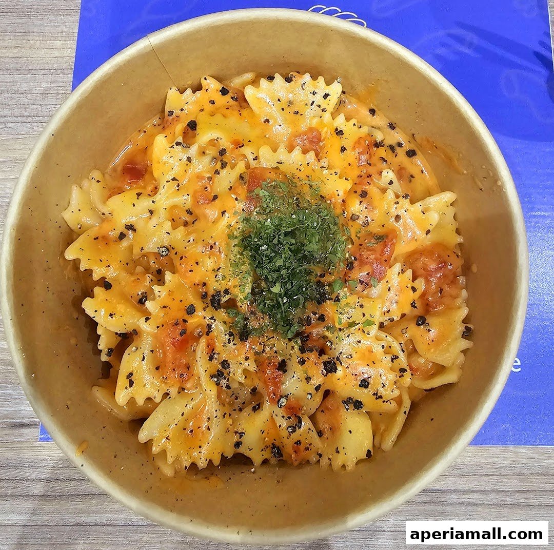 A close-up shot of a bowl of delicious-looking pasta with cheese and herbs.