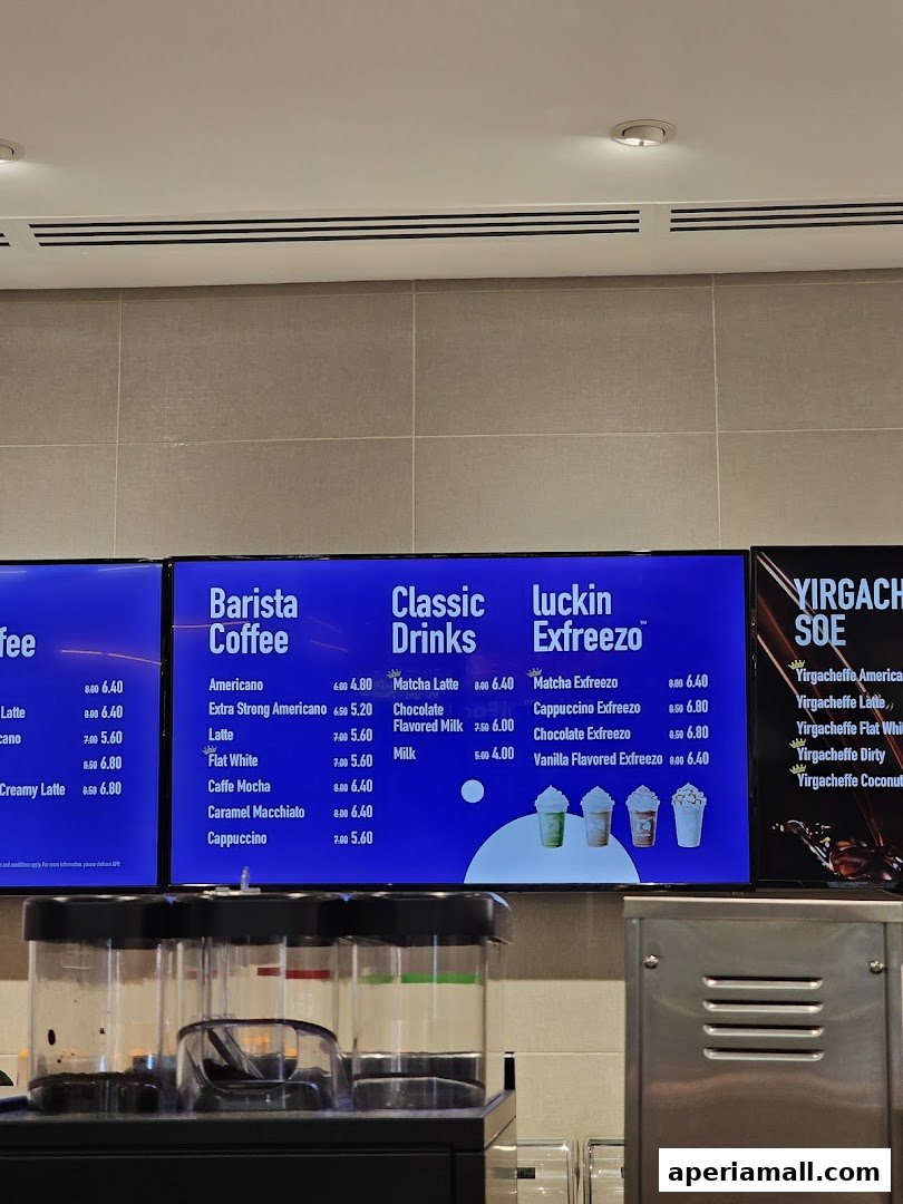 A digital menu board displaying various coffee drinks and their prices at Luckin Coffee.