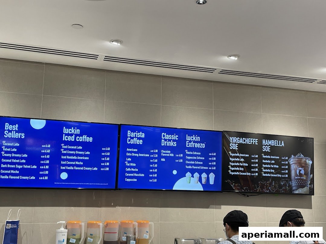 Digital menu boards displaying various coffee drinks and their prices at Luckin Coffee.