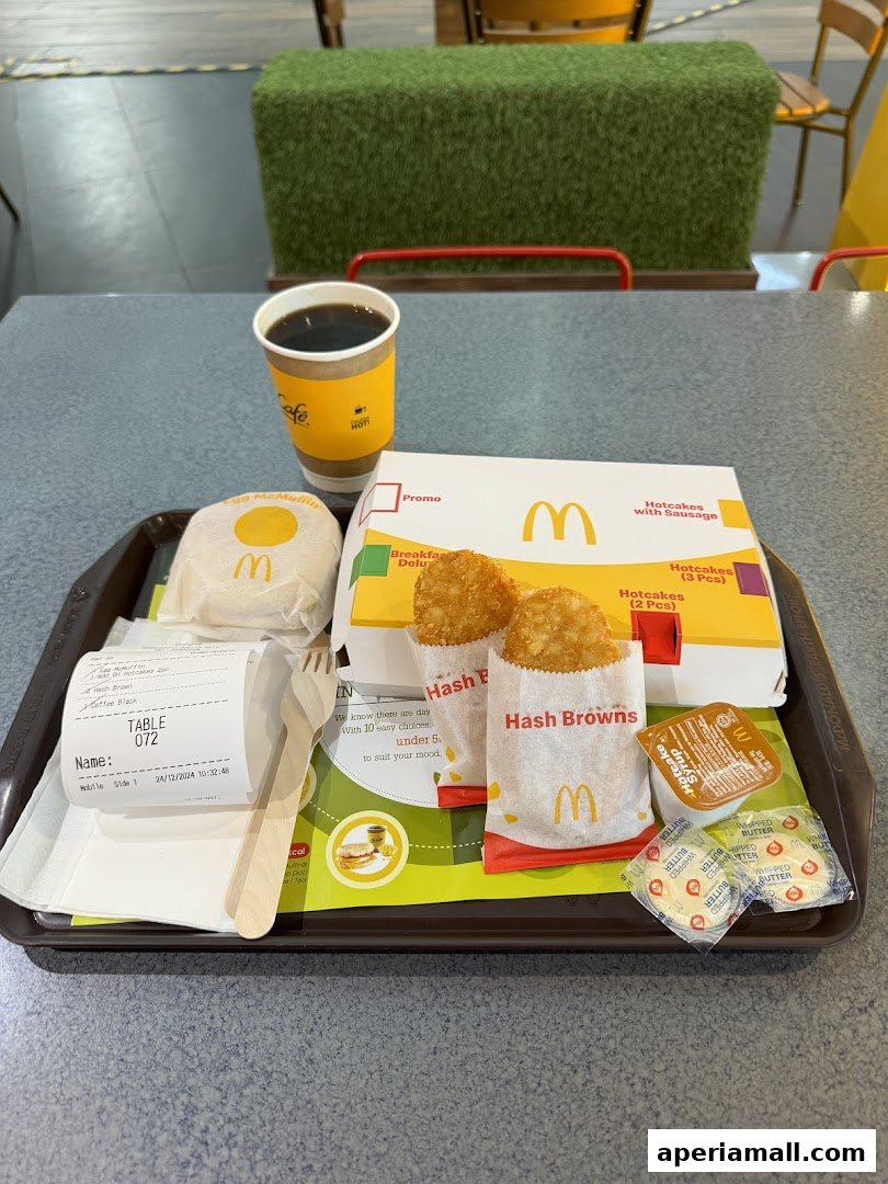 A McDonald's breakfast tray with hotcakes, hash browns, coffee, and a receipt.