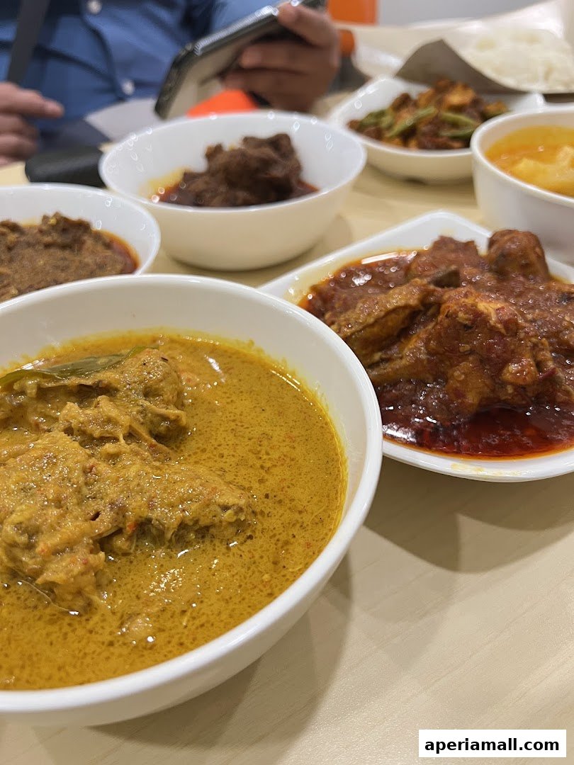 A close-up of several bowls of delicious-looking curry and meat dishes.