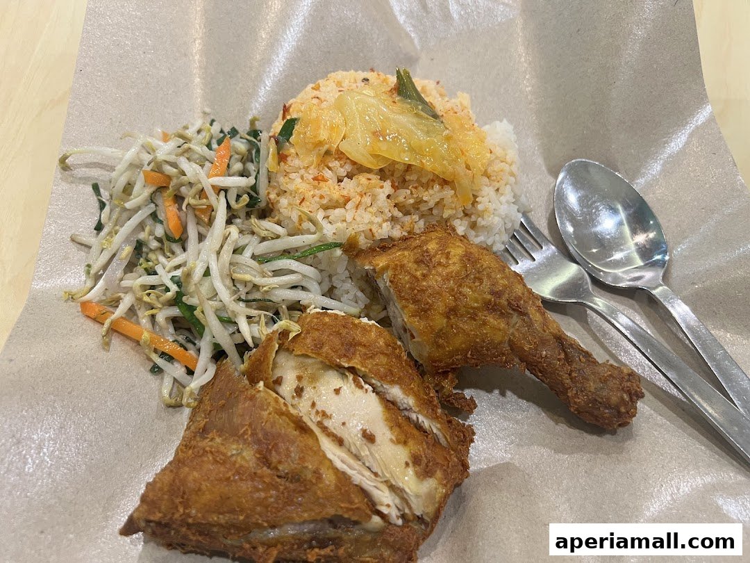 A close-up of a delicious fried chicken meal with rice and bean sprouts.