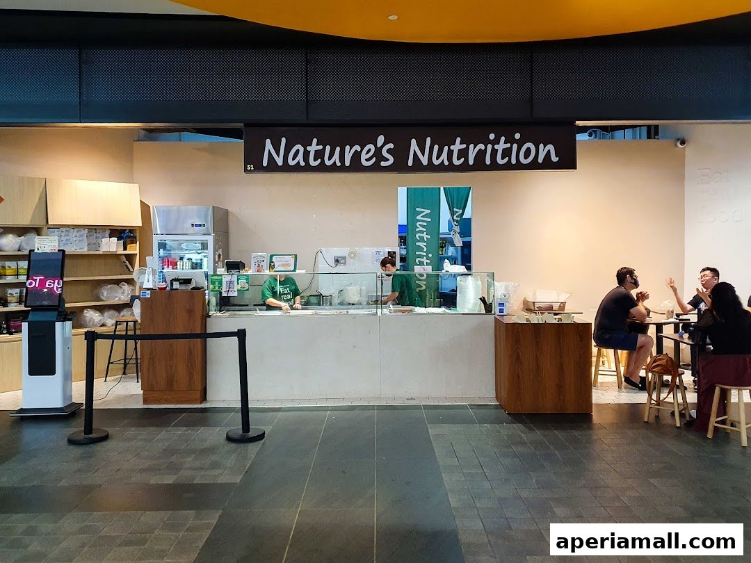 Natures Nutrition shop front with staff preparing food and customers dining.