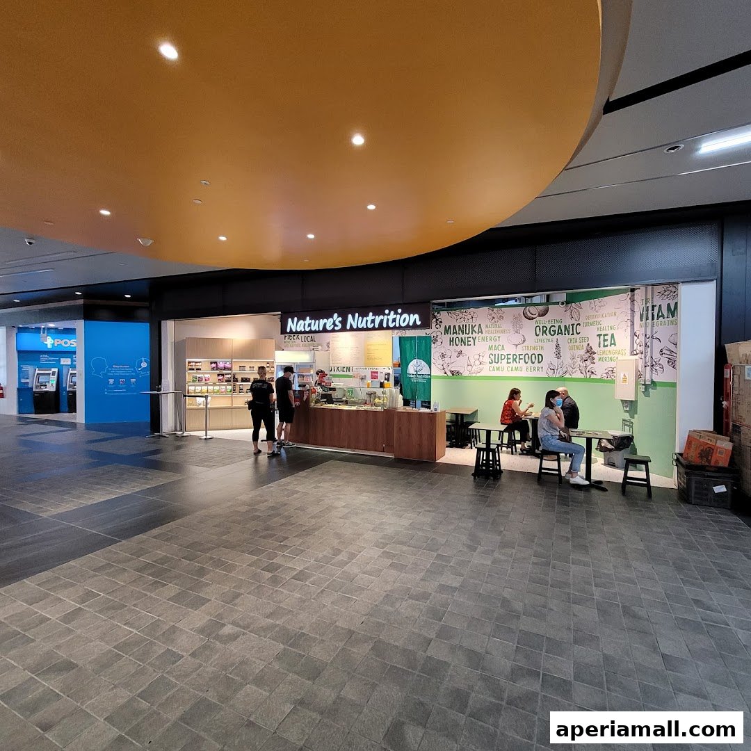 The exterior of Nature's Nutrition, a healthy food shop with seating and a display of products.