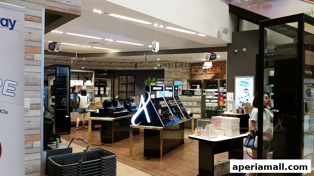 Interior view of a Nutrilite shop showcasing health and beauty products with displays and customers.